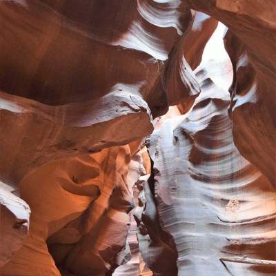 Sunlight filtering through narrow sandstone canyon walls.